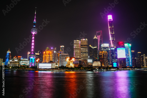 Night view of the illuminated skyline of Shanghai from the Bund, with the reflection of the lights in the river; Lujiazui, Shanghai, China