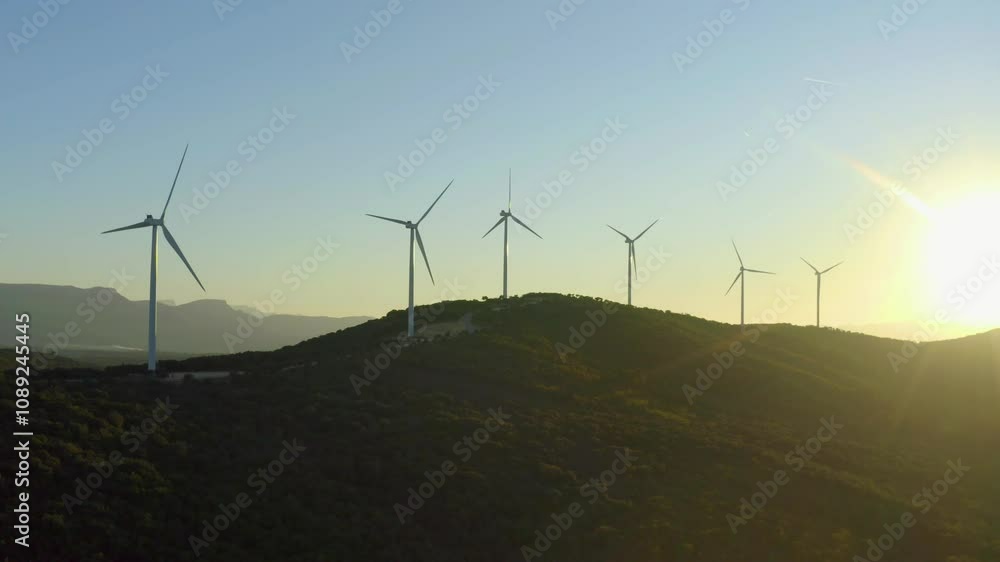 Aerial shot of wind turbines turning at sunset in unspoilt nature, Provence, France Aerial shot of wind turbines turning at sunset in unspoilt nature, Provence, France