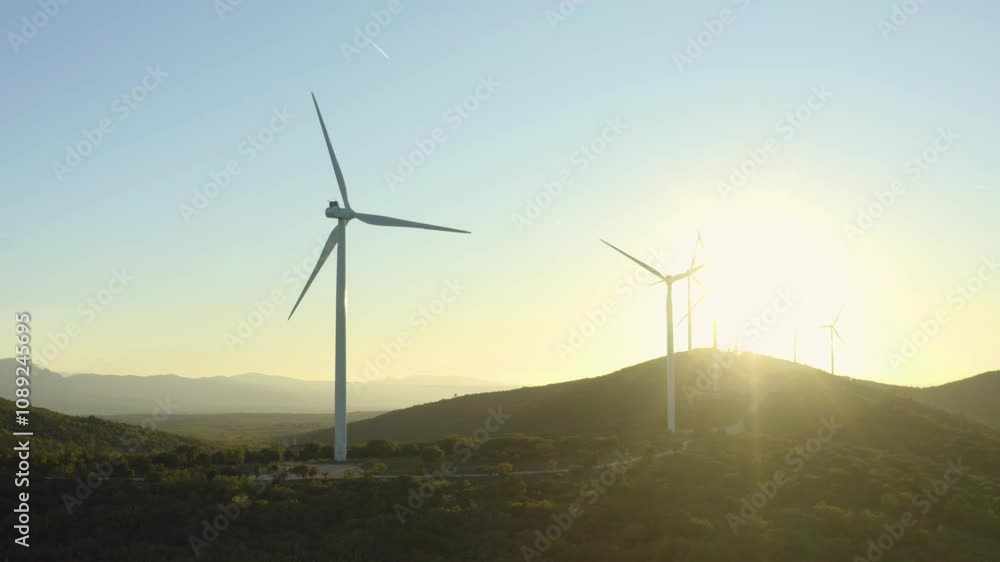 Aerial shot turning around wind turbines turning at sunset in unspoilt nature, Provence, France Aerial shot turning around wind turbines turning at sunset in unspoilt nature, Provence, France