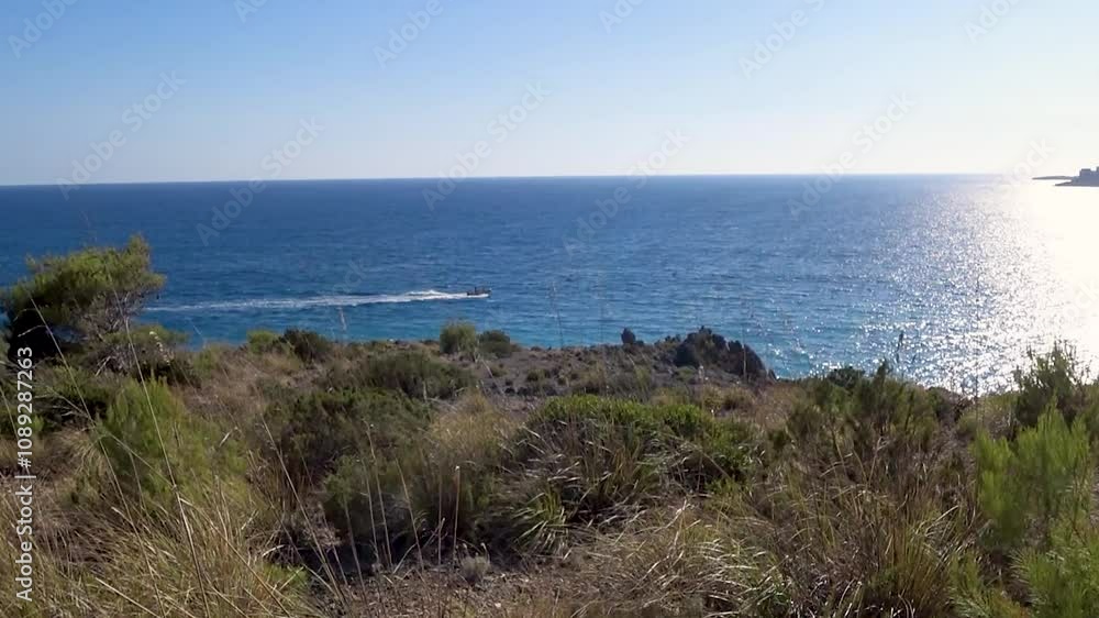 View of the coastline from the cliff with a path to the hill to enjoy the panorama. Marina di Camerota, Salerno, Italy. View of the coastline from the cliff with a path to the hill to enjoy the panorama. Marina di Camerota, Salerno, Italy.