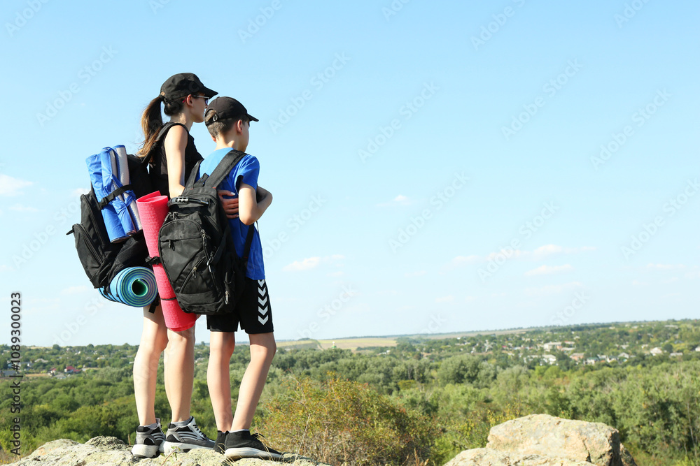 Mother and son enjoying picturesque landscape, back view. Space for text Mother and son enjoying picturesque landscape, back view. Space for text