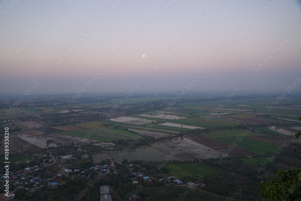 Fototapeta premium Sunrise over vast fields rural landscape aerial view tranquil morning nature's beauty expansive horizon