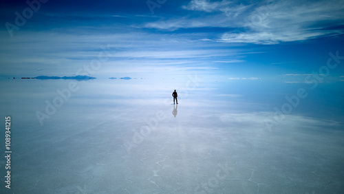 Lone Figure Under the Blue Sky at Uyuni Salt Flats