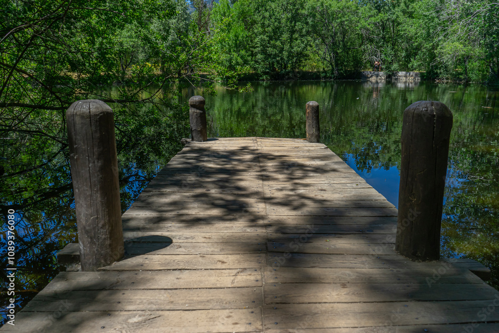 Wooden Pier in the Serene Finnish Forest of Rascafría Wooden Pier in the Serene Finnish Forest of Rascafría
