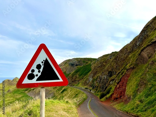 Falling Rocks Warning Sign on a Scenic Coastal Road