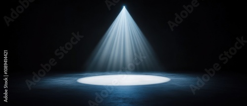 dramatic spotlight illuminating a dark stage