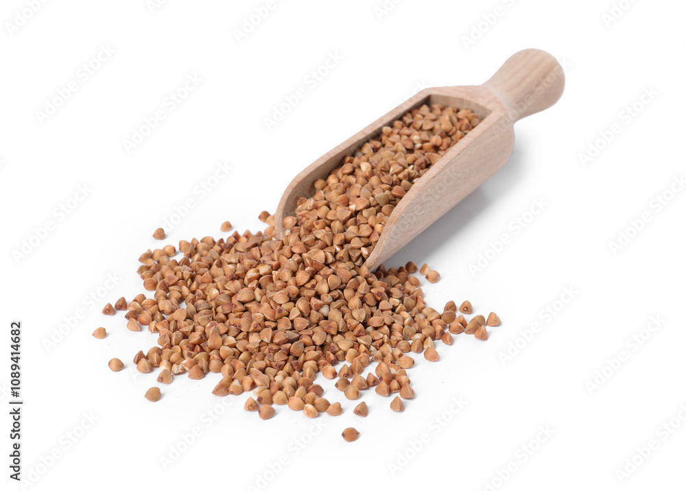 Raw buckwheat in wooden scoop isolated on white Raw buckwheat in wooden scoop isolated on white