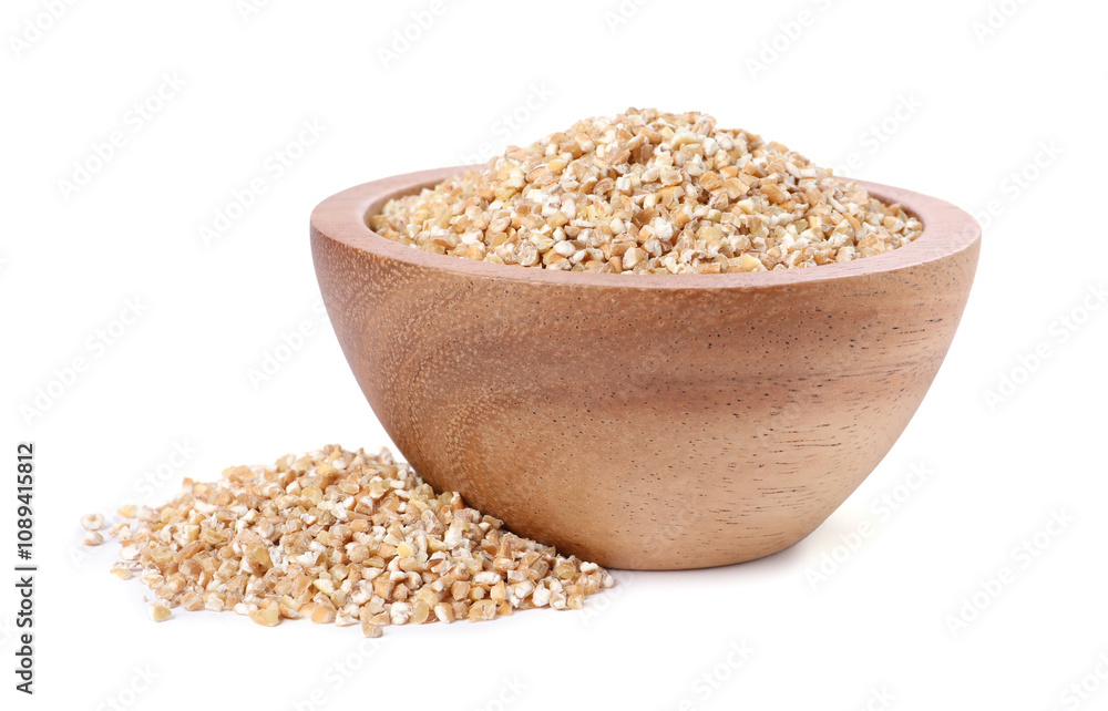 Dry wheat groats in wooden bowl isolated on white Dry wheat groats in wooden bowl isolated on white