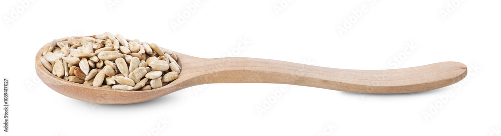 Peeled sunflower seeds in wooden spoon isolated on white