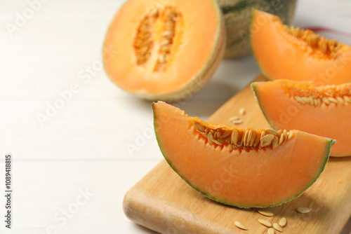 Cut ripe Cantaloupe melon on white table, closeup. Space for text