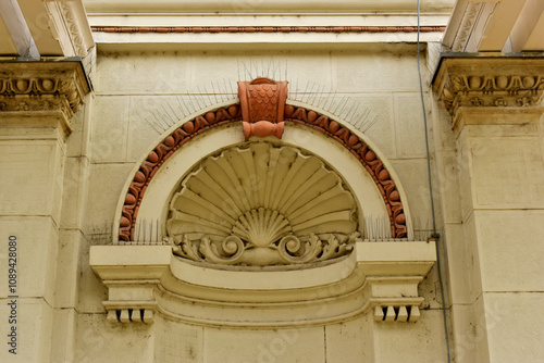 metal spike anti-roosting or bird prevention and repellent strip. bird control. old exterior stucco elevation detail. sharp needles. old European building detail and architecture. pigeon prevention photo