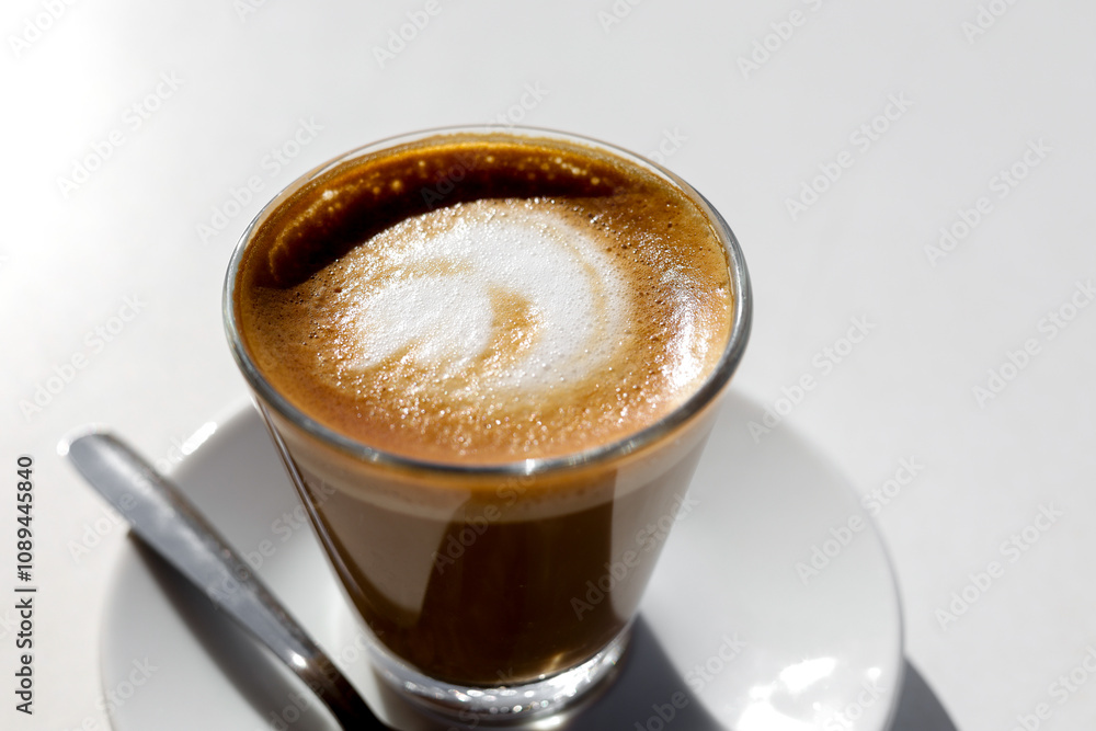 Traditional espresso coffee in cup on white table, top view. Traditional espresso coffee in cup on white table, top view.