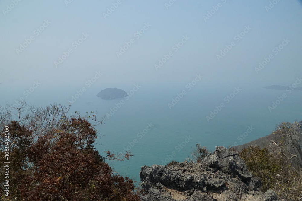 Breathtaking coastal view of a serene island from rocky cliffs scenic nature landscape tranquil atmosphere wide angle perspective Breathtaking coastal view of a serene island from rocky cliffs scenic nature landscape tranquil atmosphere wide angle perspective