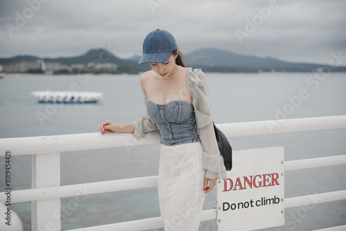 Woman with ocean view and Okinawa glass bottom boat Busena marine park Okinawa, Japan. photo