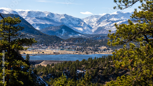 Nestled in a picturesque valley at the foot of the majestic, snow-capped Rocky Mountains, the charming town of Estes Park, Colorado, unfolds beside a serene blue lake