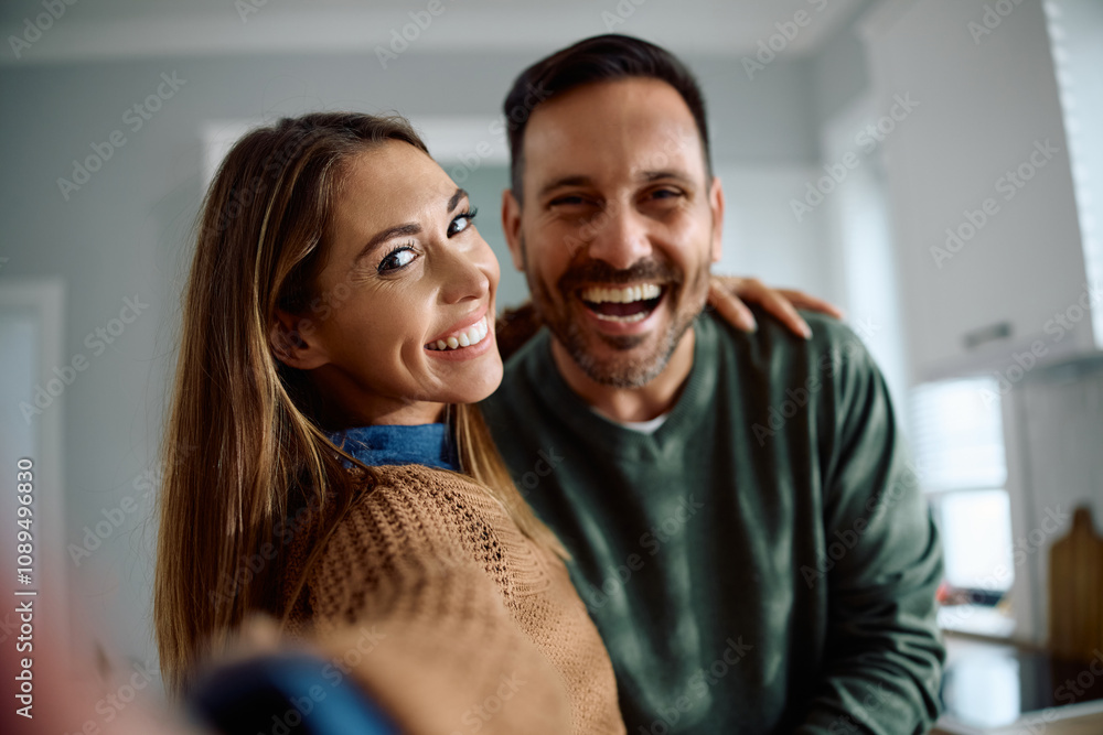 Cheerful couple having fun while taking selfie and looking at camera. Cheerful couple having fun while taking selfie and looking at camera.