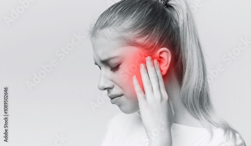 Tableau sur toile Young woman with sore ear, suffering from otitis, black and white panorama with