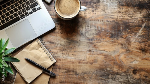 Work from home. desk office with laptop, blank notepad, coffee cup and pen on wood table. Flat lay top view copy space.