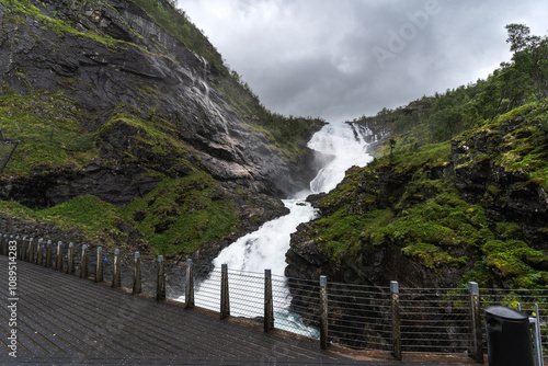 Kjosfossen waterfall, next to one of the stops of the tourist train between Flam and Myrdal, surrounded by vegetation and without people photo