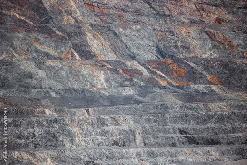 Geological Strata Layers Revealing Erosion Patterns in Rocky Terrain from open pit mine industry. photo