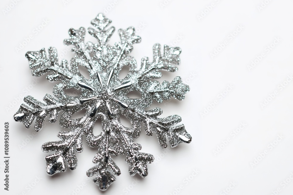 Sparkling silver snowflake on white background Sparkling silver snowflake on white background