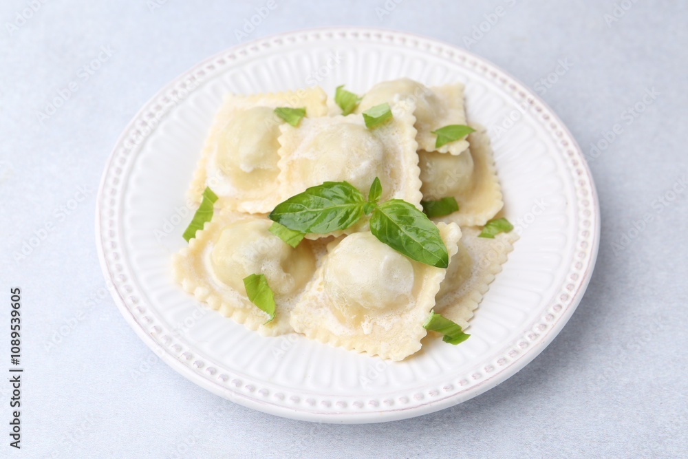 Delicious ravioli with cheese and basil on light table, closeup Delicious ravioli with cheese and basil on light table, closeup