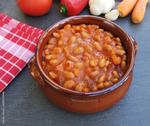 Tasty baked beans on tomato sauce photo