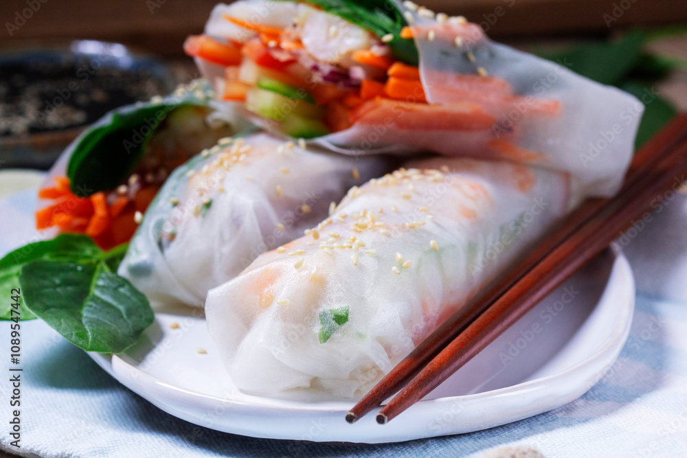 Summer or spring rolls with shrimp, vegetables and spinach, served with soy sauce and sesame. Traditional Vietnamese food.