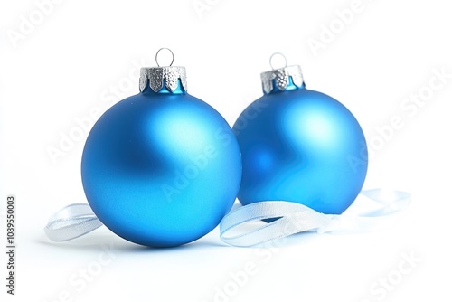 Two shiny blue Christmas ornaments on a white background