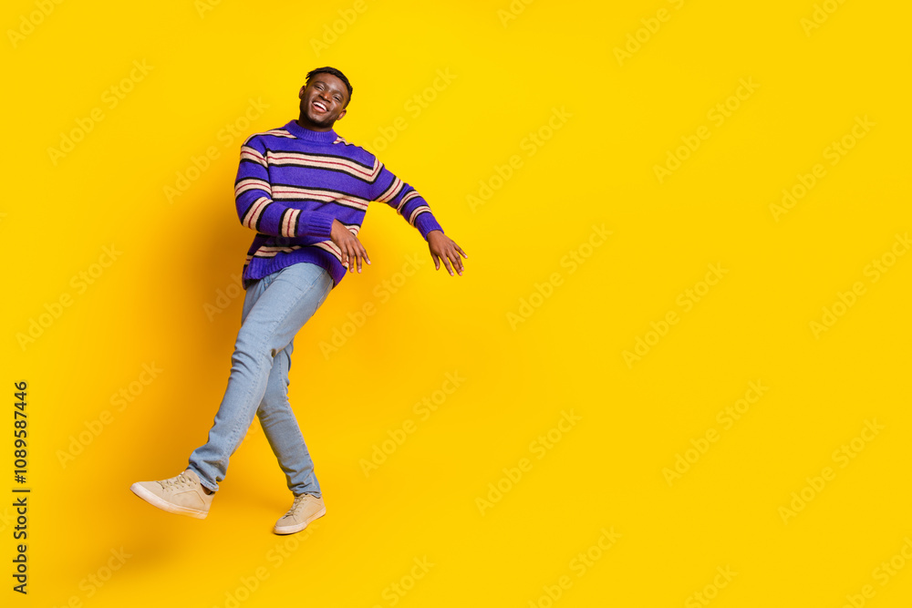 Full body portrait of nice young man dancing empty space isolated on yellow color background Full body portrait of nice young man dancing empty space isolated on yellow color background