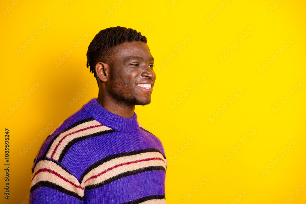 Profile portrait of nice young man look empty space wear sweater isolated on yellow color background Profile portrait of nice young man look empty space wear sweater isolated on yellow color background