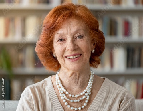 Happy Grandmother Sitting and Smiling Indoors photo