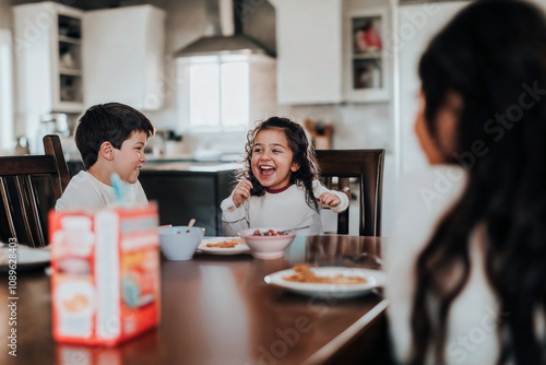 Children laughing and enjoying breakfast together in a family kitchen setting