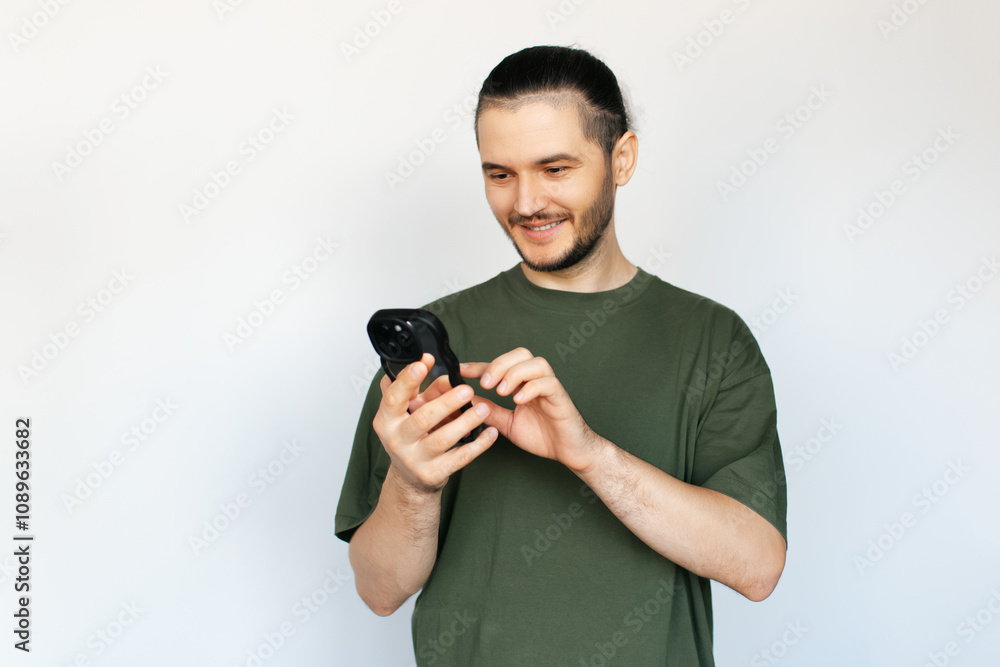 Portrait of young man, typing on smartphone, on white background. Portrait of young man, typing on smartphone, on white background.