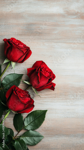 Three red roses with green leaves on wooden background, symbolizing love and beauty. Perfect for romantic occasions.  valentine