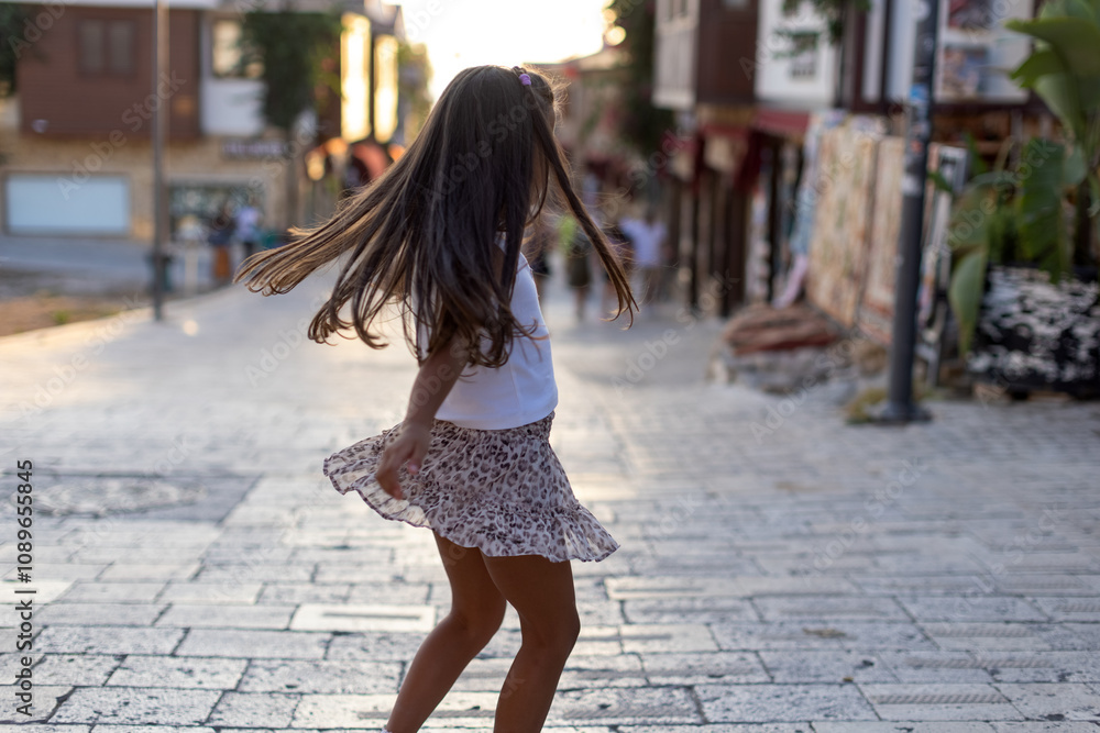 Joyful Moments: Girl Spins Around in a Leopard Skirt Outdoors Joyful Moments: Girl Spins Around in a Leopard Skirt Outdoors