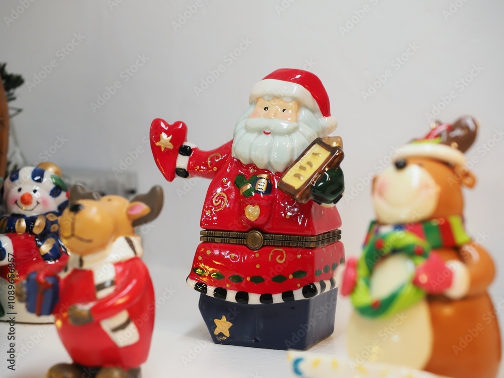 Christmas ceramic figures of Santa Claus. American holiday Christmas decoration. Santa Claus in family interior decorating a home. Christmas ceramic figures of Santa Claus. American holiday Christmas decoration. Santa Claus in family interior decorating a home.