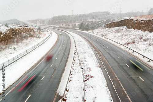 Long exposure motion blur of traffic on the A465 at Ebbw Vale during a winter snow storm photo