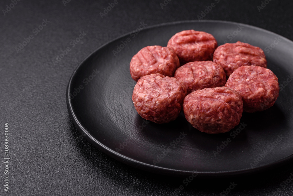 Raw meatballs of minced meat beef, pork or chicken with salt, spices Raw meatballs of minced meat beef, pork or chicken with salt, spices