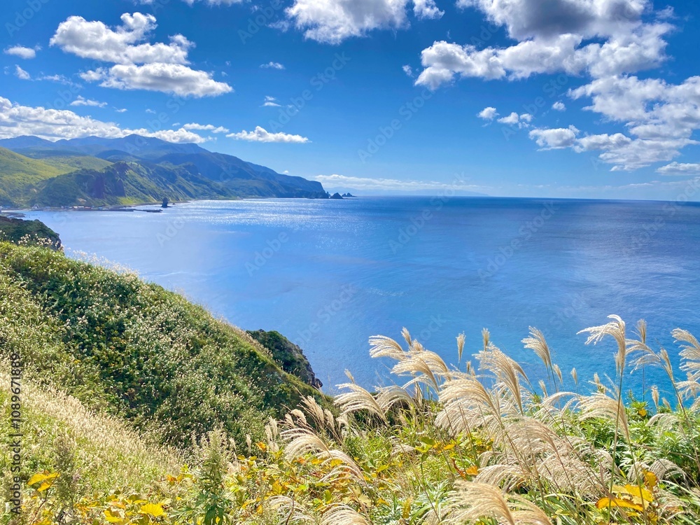 Scenic coastal landscape with blue ocean and green hills. Scenic coastal landscape with blue ocean and green hills.