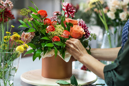 The hands of florist, making bouquets and flower arrangements. Woman collecting a bouquet of flowers. floristry