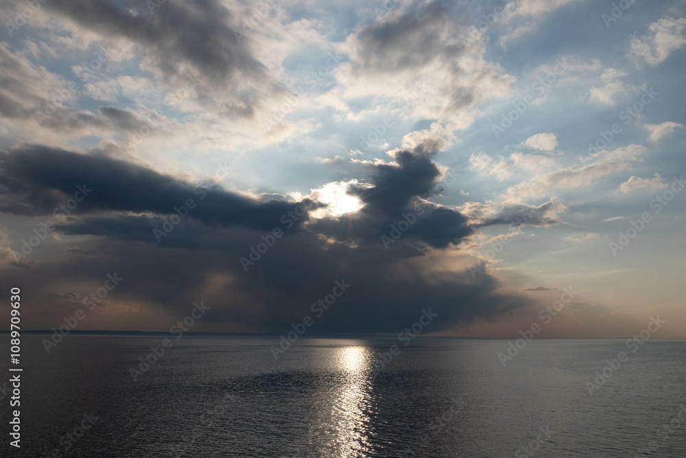Fototapeta premium blue sky above river landscape with clouds and sunset