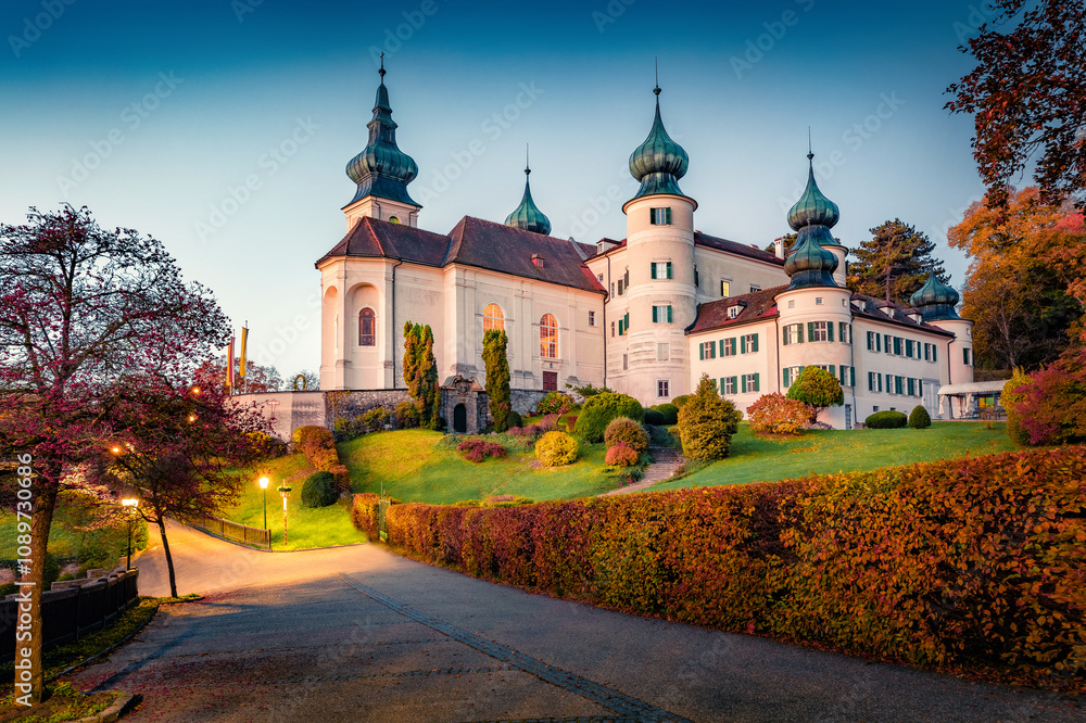 Fantastic autumn dawn in Austrian countryside with Castle parish church of St. Jacob D. A. Artstetten. Stunning morning cityscape of Artstetten-Pobring town, district of Melk, Austria, Europe.