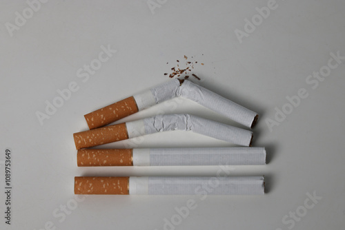 Broken cigarettes on a white background