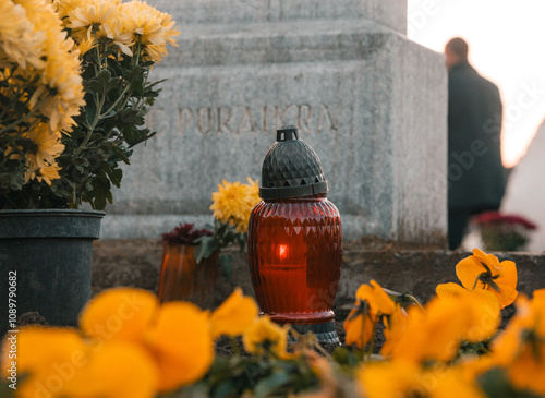 candles and flowers on a grave