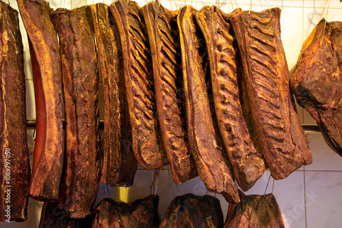 tyrol speck hanging in a butchery in Austria photo