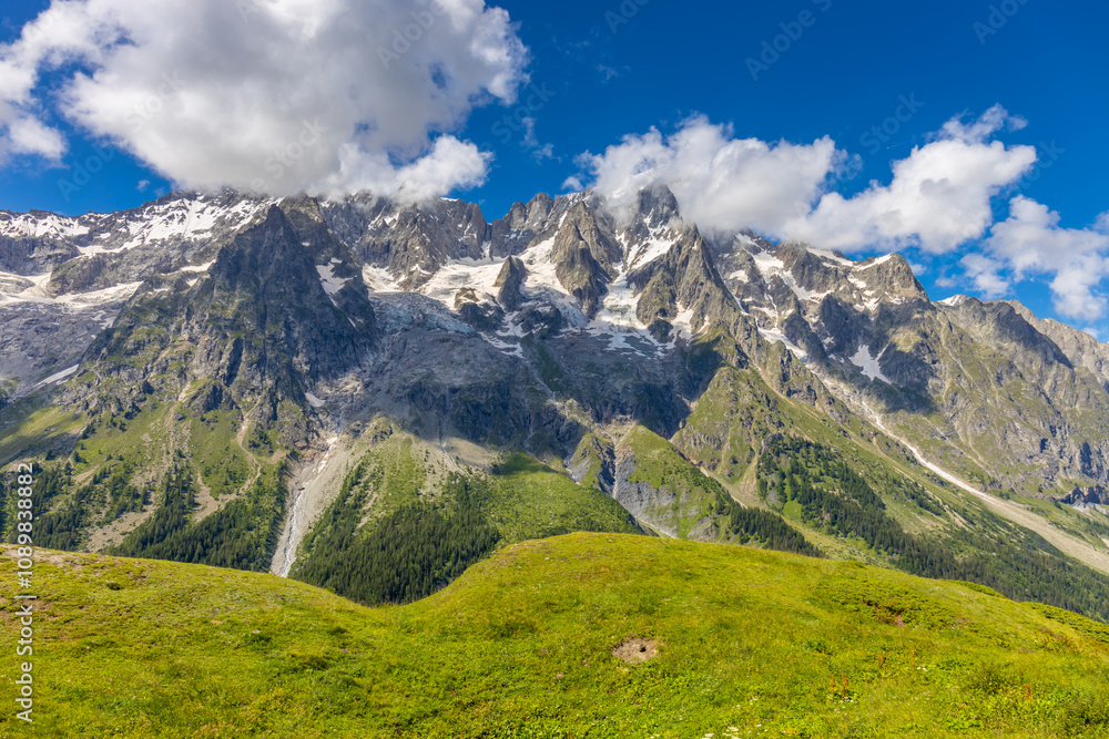 Obraz premium Val Ferret, located on the Tour du Mont Blanc in Italy, a picturesque mountain landscape. Ideal for photography, it features alpine peaks, lush valleys, and scenic trails in Courmayeur, Italy