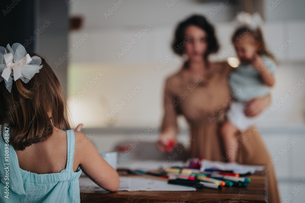 Fototapeta premium A mother shares a precious moment with her two young daughters. Captured in a warm, cozy home environment filled with affection and family bonding.
