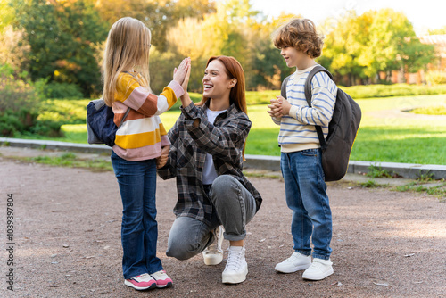 Volunteer or camp teacher spending time with kids in park