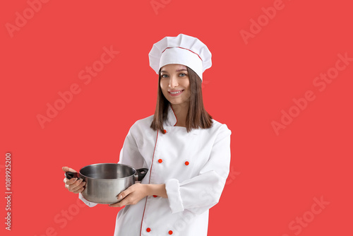 Young female chef with cook...